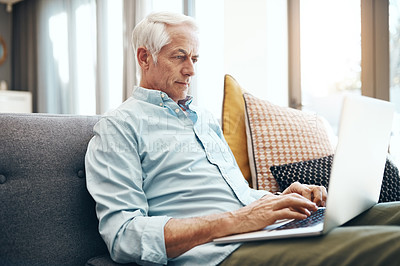 Buy stock photo Senior man, laptop and relax in home for typing email, communication and reading online news. Elderly person, technology and retirement on sofa in lounge for bills payment, webinar and writing ebook