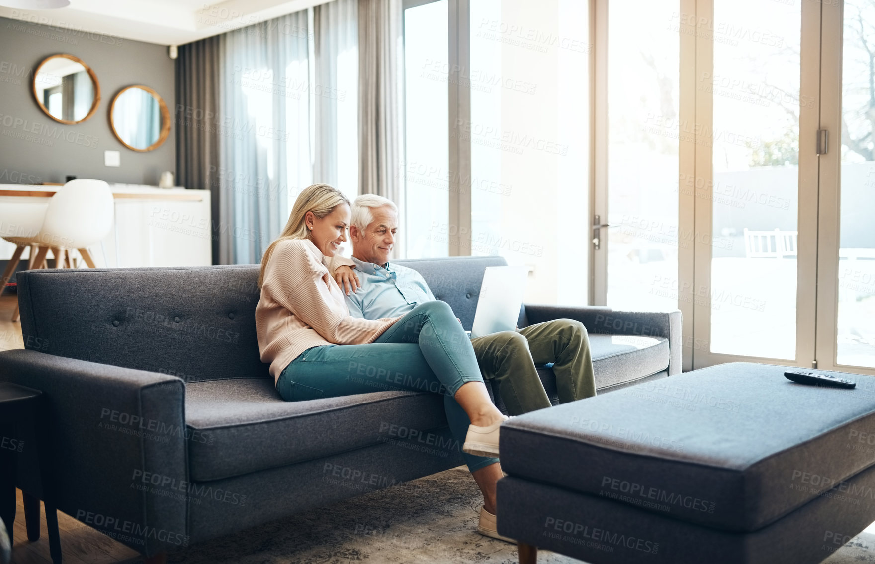 Buy stock photo Shot of mature couple using a laptop on the sofa at home