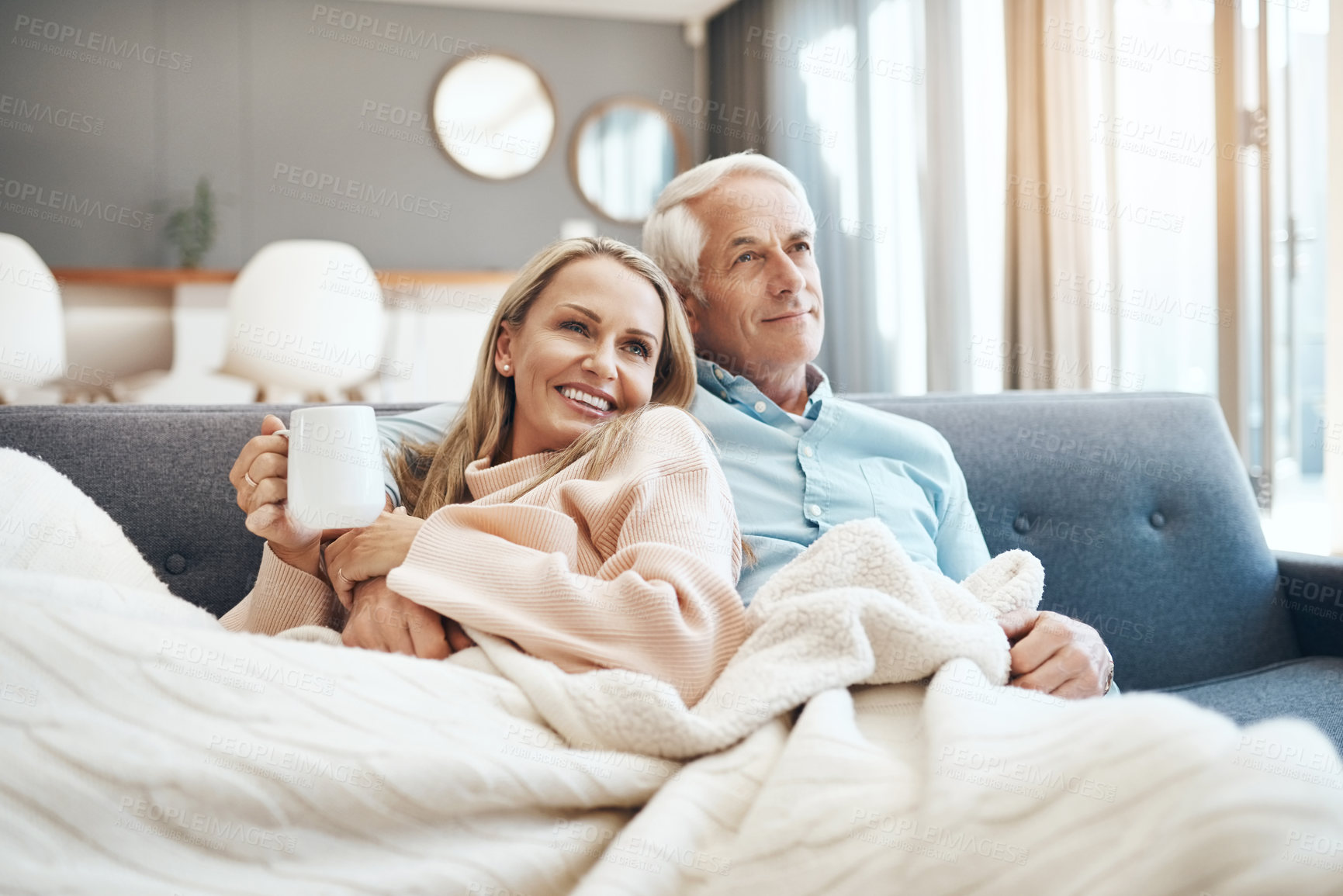Buy stock photo Cropped shot of a mature couple relaxing on the sofa at  home