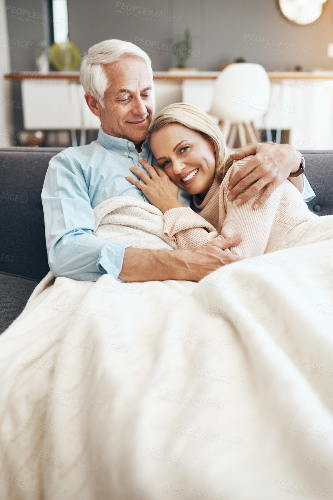 Buy stock photo Cropped shot of an affectionate mature couple relaxing on the sofa at  home