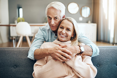 Buy stock photo Hug, portrait and mature couple in home with love, healthy relationship and loyalty to partner on sofa. Face, senior man and happy woman embrace together for trust, support or holding hands in Canada