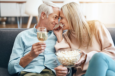 Buy stock photo Cropped shot of an affectionate mature couple relaxing on the sofa at home