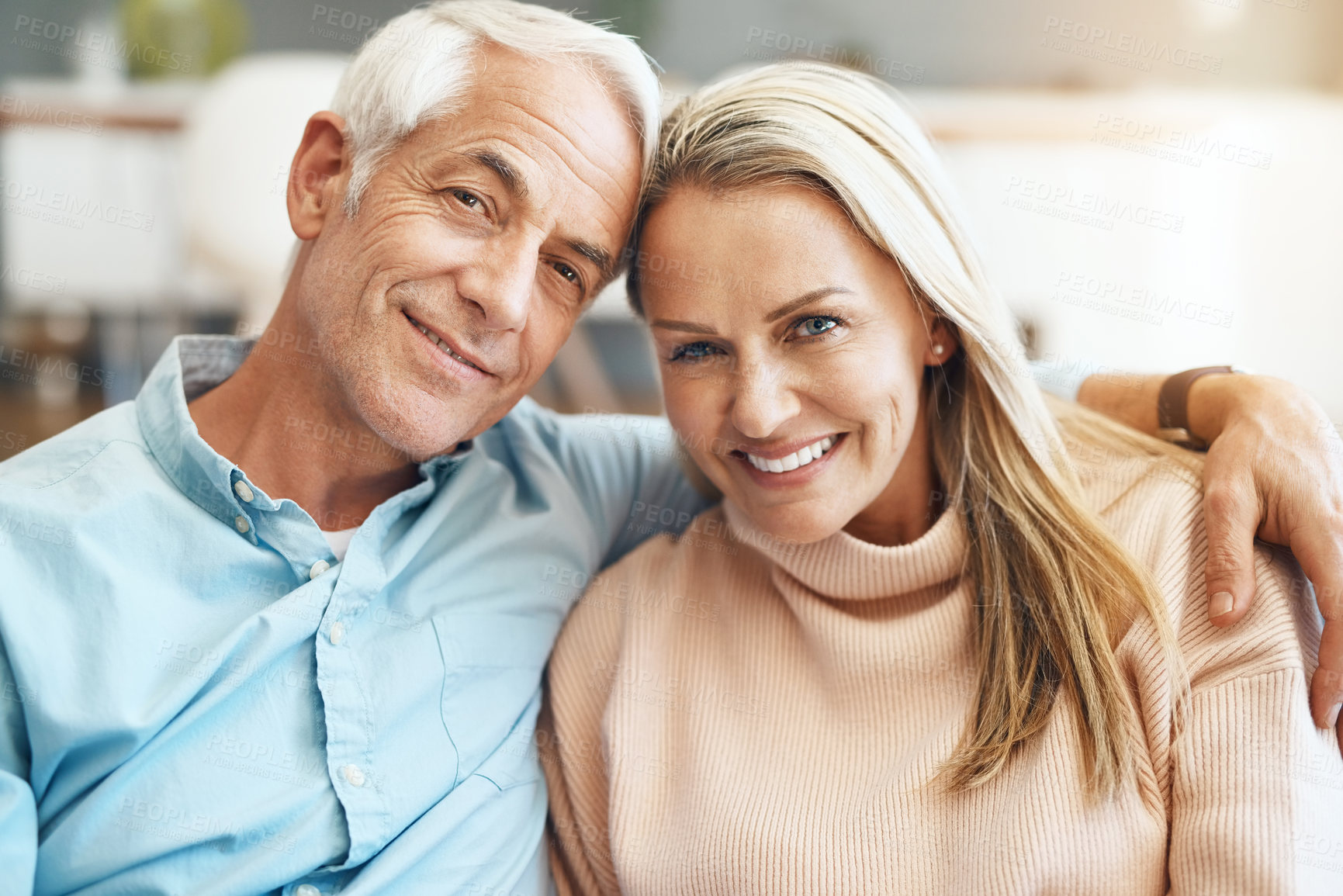 Buy stock photo Cropped shot of  an affectionate mature couple relaxing on the sofa at home