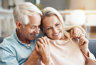 Buy stock photo Cropped shot of  an affectionate mature couple relaxing on the sofa at home