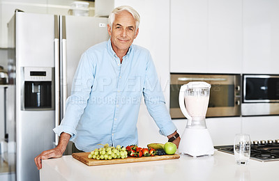 Buy stock photo Cropped portrait of a handsome mature man preparing a healthy nack at home