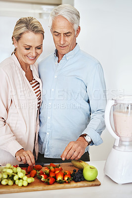 Buy stock photo Cropped shot of an affectionate mature couple preparing a healthy snack at home