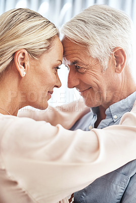 Buy stock photo Cropped shot of an affectionate mature couple standing face to face in their home