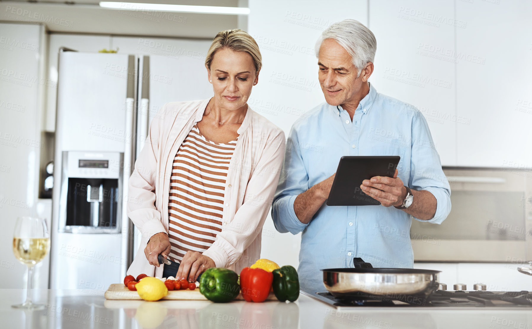 Buy stock photo Cropped shot of an affectionate mature couple preparing a healthy meal at home
