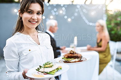 Buy stock photo Shot of a young waitress serving a mature couple on a romantic date