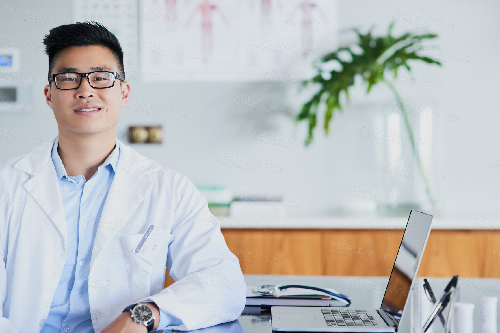 Buy stock photo Cropped portrait of a young male doctor working in his office in the hospital