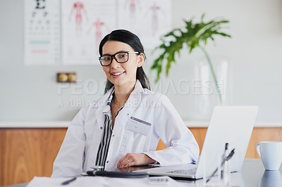 Buy stock photo Cropped portrait of a young female doctor working in her office in the hospital
