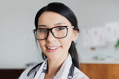 Buy stock photo Cropped portrait of a young female doctor standing in her office in the hospital