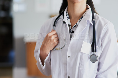 Buy stock photo Cropped shot of an unrecognizable female doctor standing in her office in the hospital