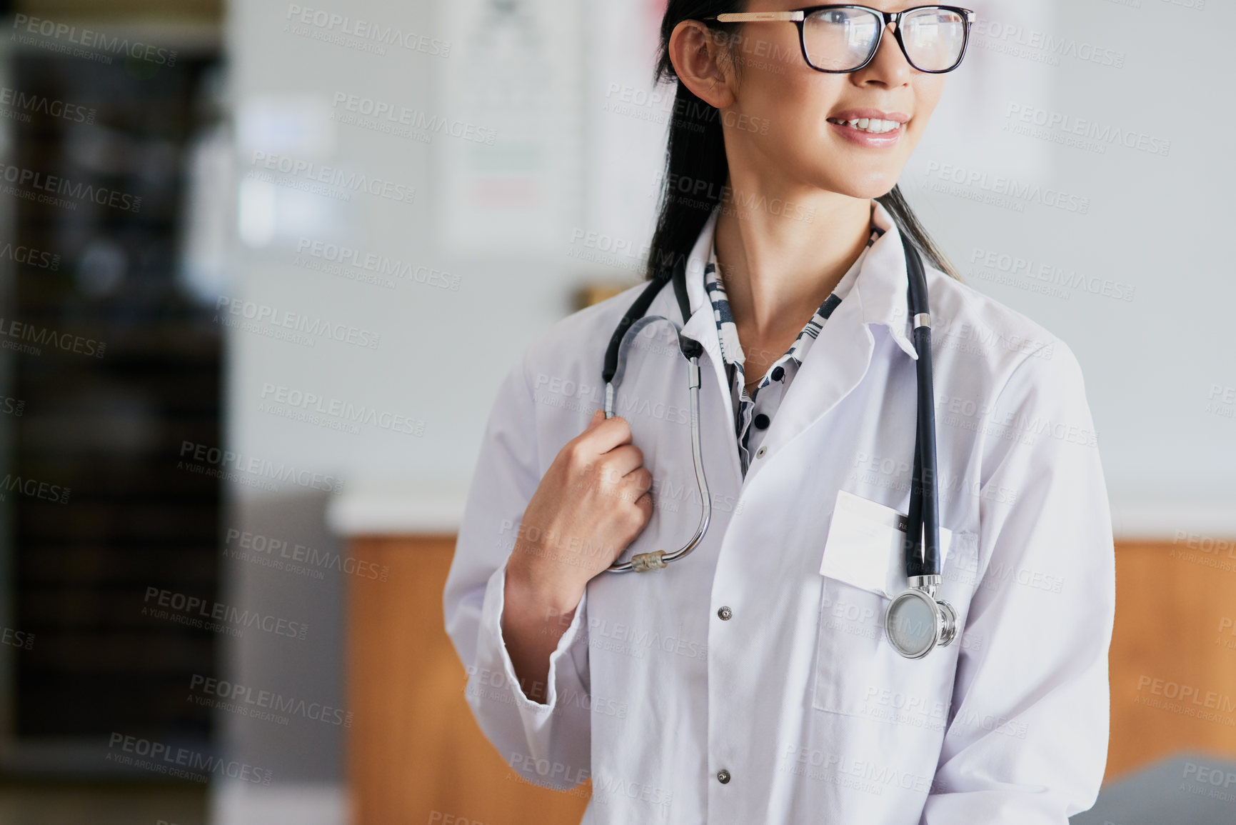 Buy stock photo Cropped shot of a young female doctor standing in her office in the hospital