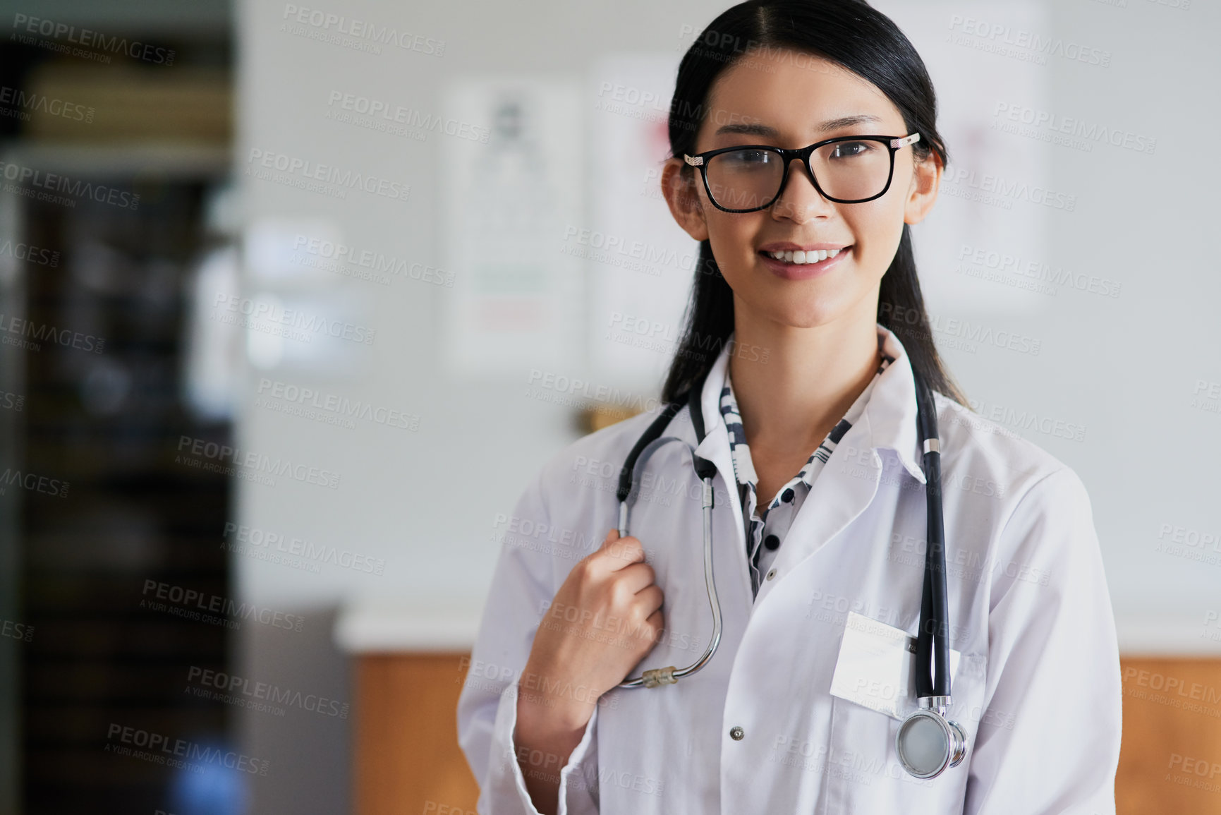 Buy stock photo Cropped portrait of a young female doctor standing in her office in the hospital