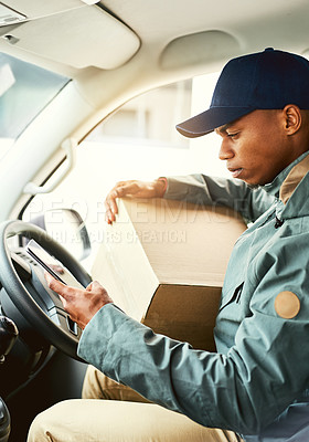 Buy stock photo Shot of a courier using a cellphone while sitting in a delivery van
