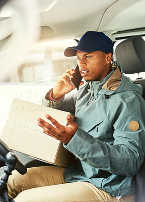 Buy stock photo Shot of a courier talking on a cellphone while sitting in a delivery van
