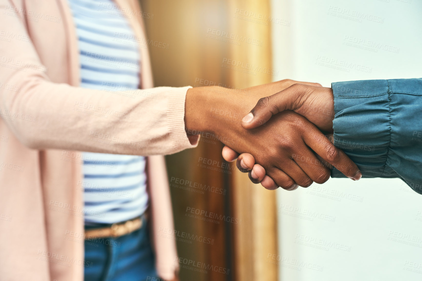 Buy stock photo Closeup shot of a courier shaking hands with a customer while making a delivery