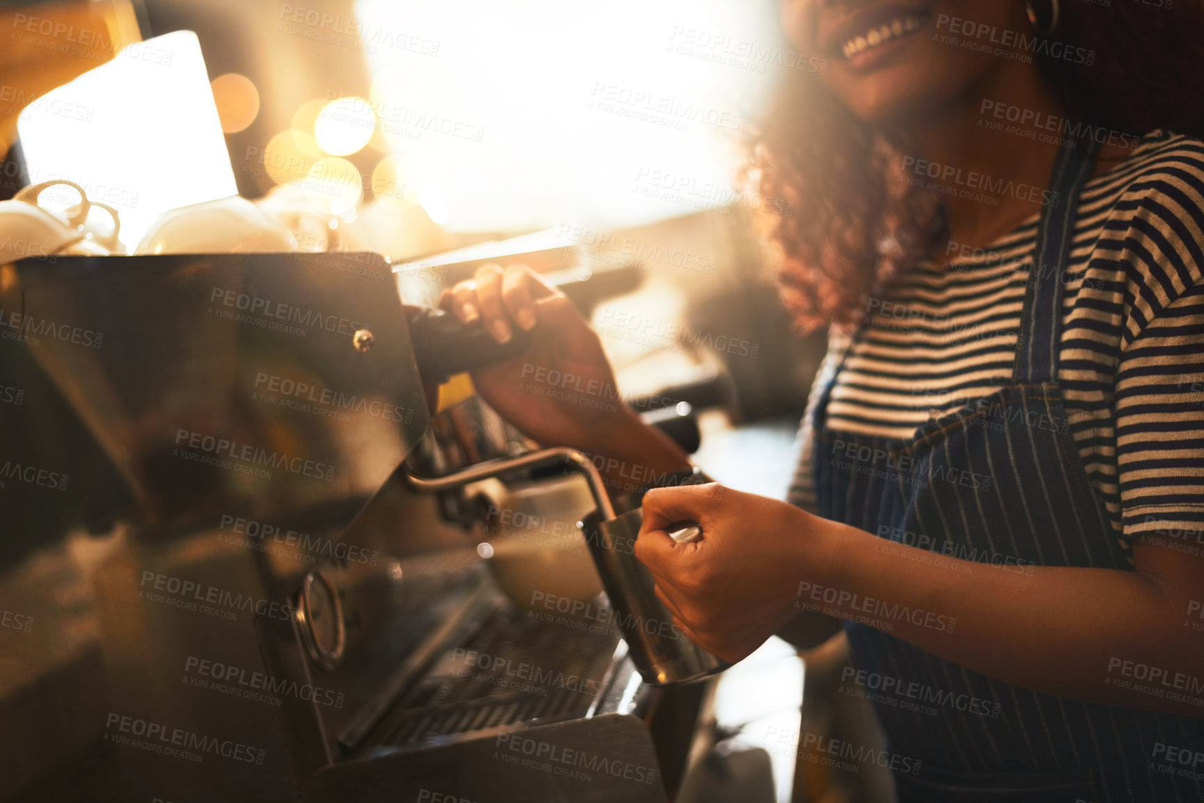 Buy stock photo Closeup shot of a barista operating a coffee machine in a cafe