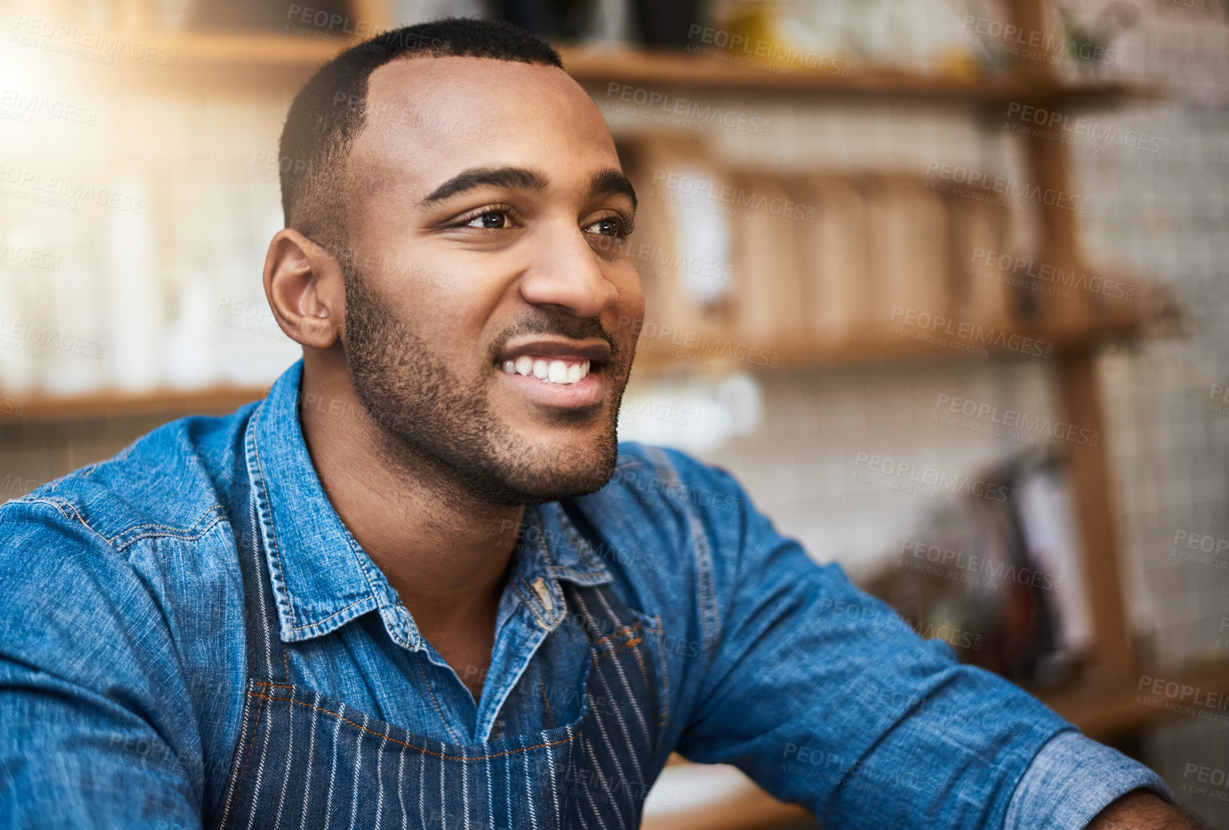 Buy stock photo Cropped shot of a handsome young man standing in his coffee shop