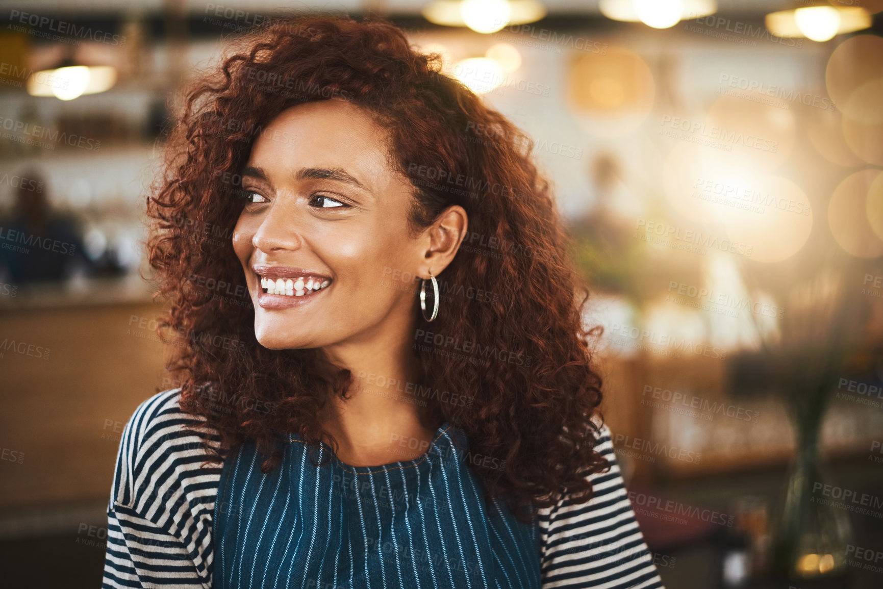 Buy stock photo Cropped shot of an attractive young woman standing in her coffee shop