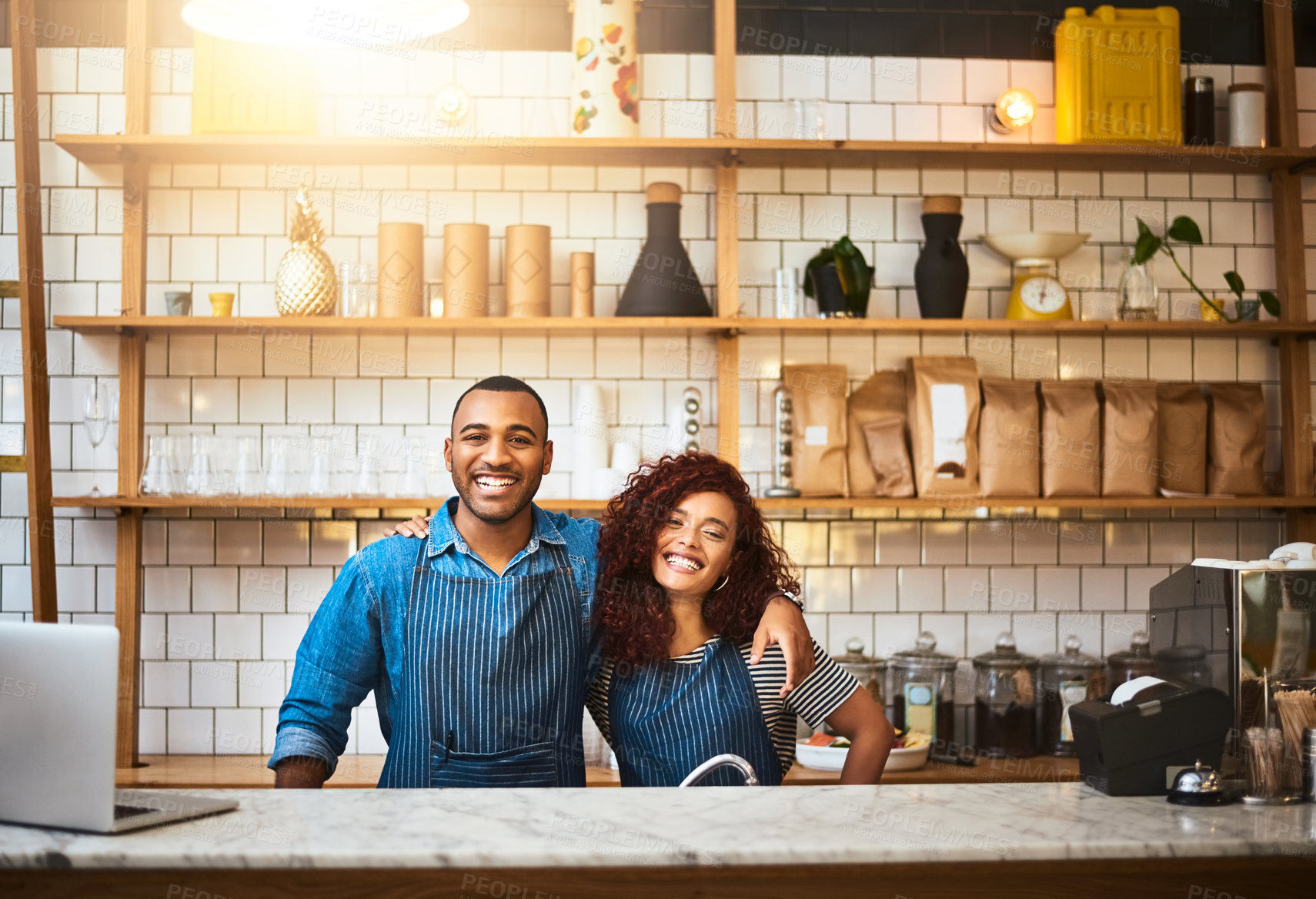 Buy stock photo Cropped portrait of an affectionate young couple standing in their coffee shop