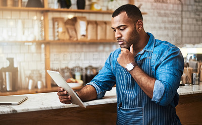 Buy stock photo Focus, tablet and thinking with man in coffee shop for online, entrepreneurship and startup. Retail, technology and food industry with small business owner in restaurant for barista, store and cafe
