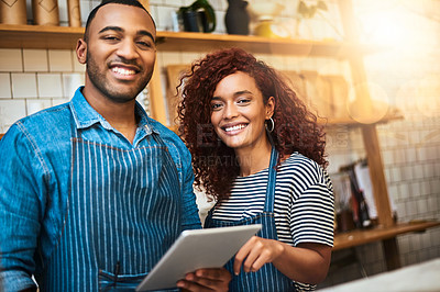 Buy stock photo Cropped portrait of an affectionate young couple working on a tablet in their coffee shop