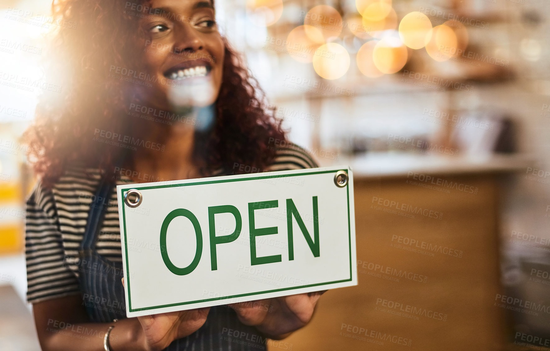 Buy stock photo Window, cafe and girl with open sign for front door announcement, welcome and coffee shop offer. Business, glass and happy woman server with storefront information at restaurant for customer service