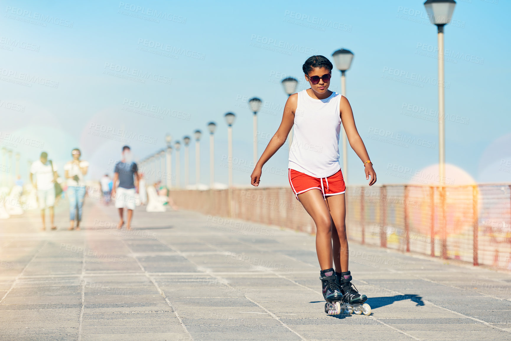 Buy stock photo Woman, rollerskate and summer with hobby for active fitness or health for exercise. Training, fun and workout with lens flare for sport with cardio or leisure in sunshine for competition in Australia