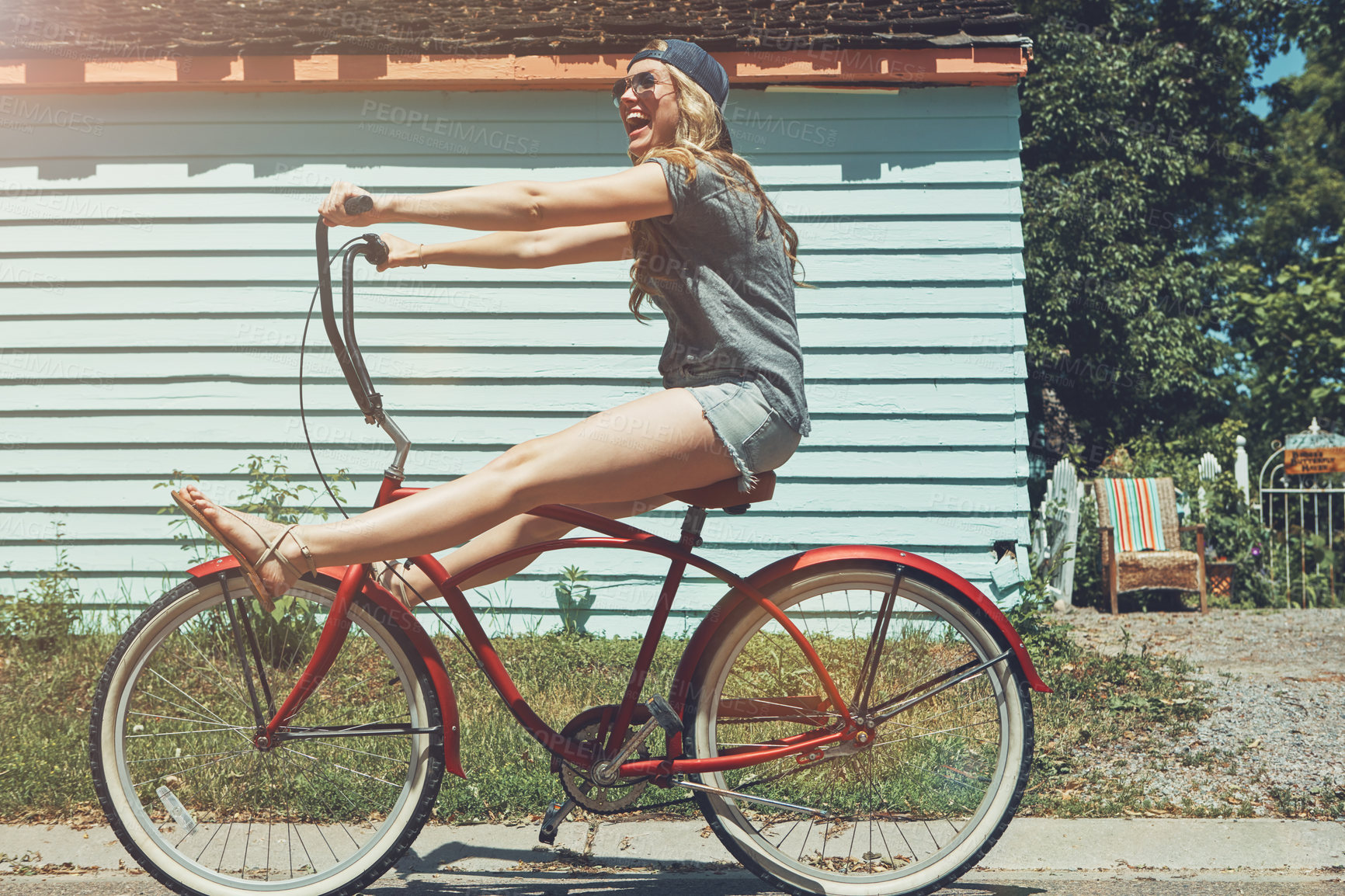 Buy stock photo Shot of an attractive young woman riding a bicycle outdoors