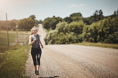 Buy stock photo Portrait of a young woman out on a trail run