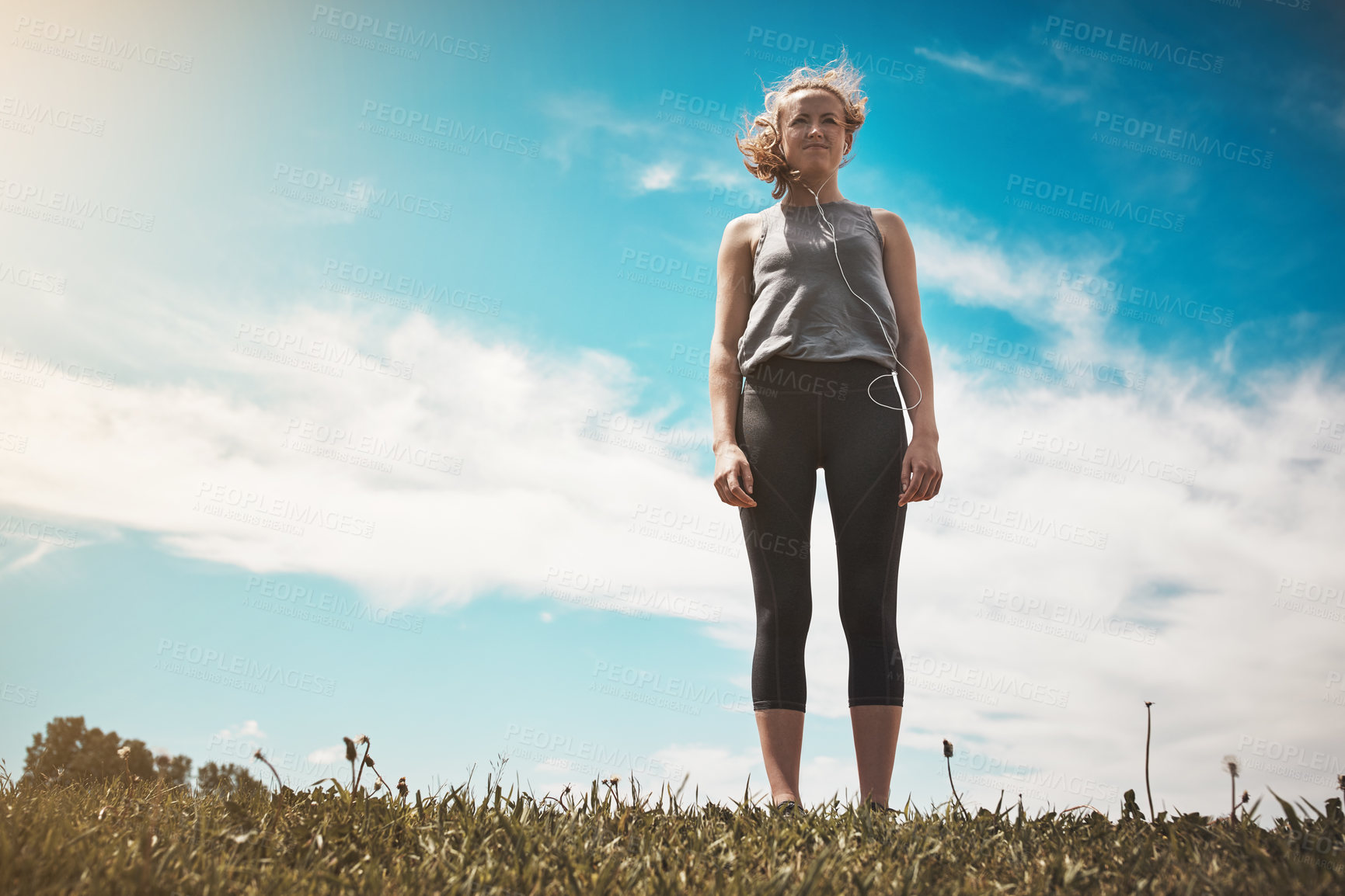 Buy stock photo Shot of a young woman taking a break while out for a run