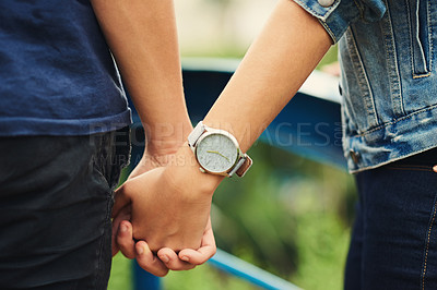 Buy stock photo Cropped shot of an unrecognizable couple holding hands outdoors