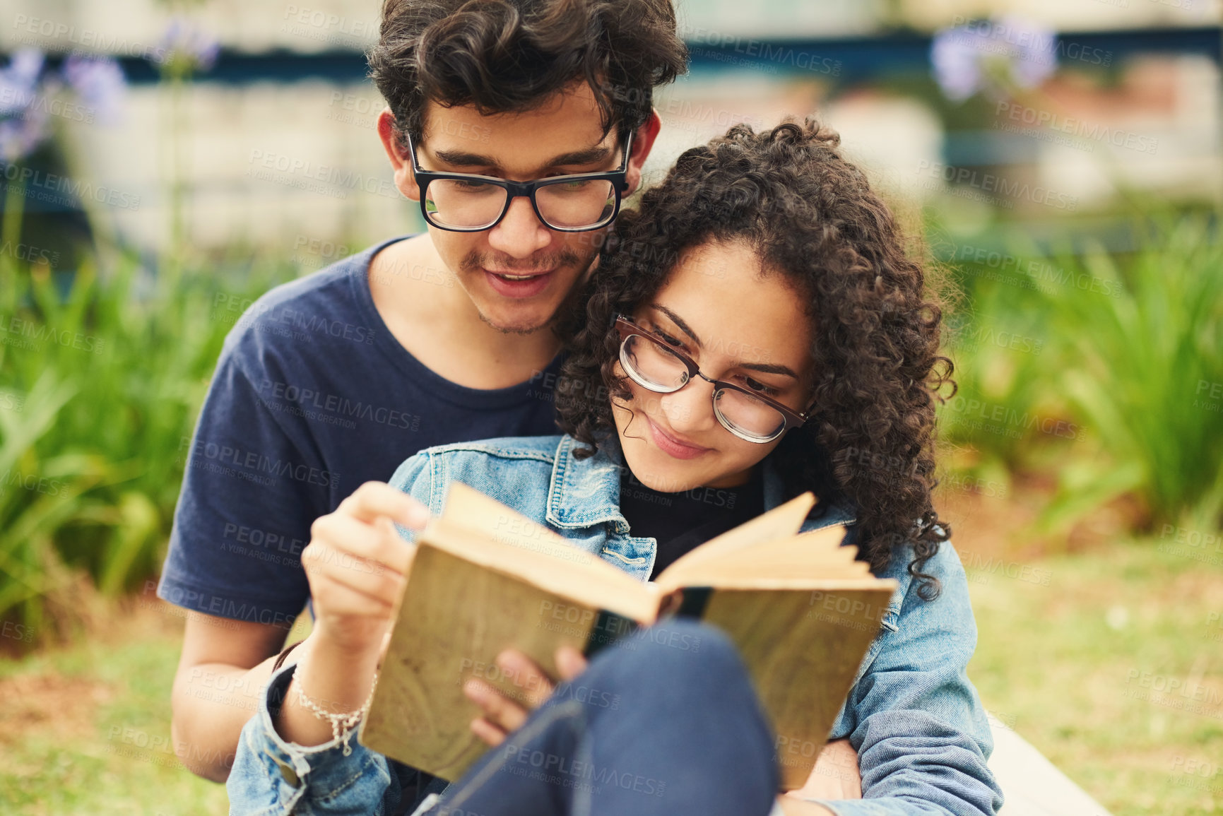 Buy stock photo Couple, teenager and book in park for reading, bonding and relax together on weekend with romance story. Boy, girl and happy for relationship, learning and fantasy novel outdoor with love connection