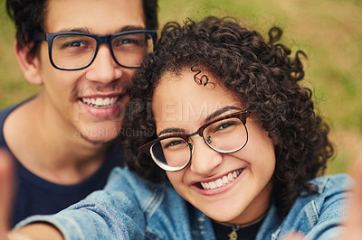 Buy stock photo Cropped shot of a teenage couple taking a selfie outdoors