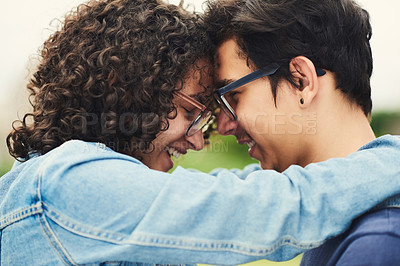 Buy stock photo Cropped shot of a teenage couple being affectionate outdoors