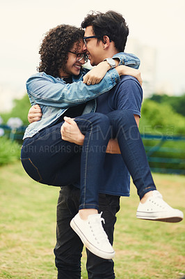 Buy stock photo Cropped shot of a teenage boy carrying his teenage girlfriend outdoors
