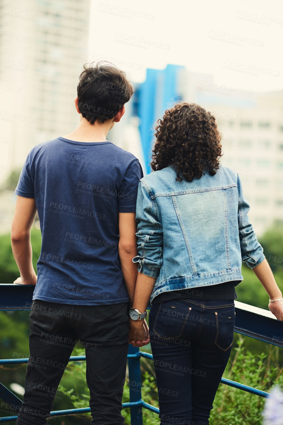 Buy stock photo Rearview shot of an unrecognizable teenage couple outdoors