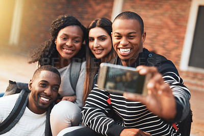 Buy stock photo Shot of a group of students taking selfies together on campus