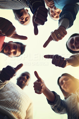 Buy stock photo Low angle shot of a group of students giving thumbs up together