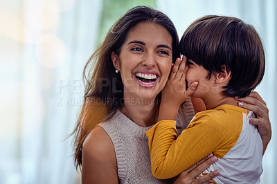 Buy stock photo Shot of an adorable little boy whispering into his mother’s ear