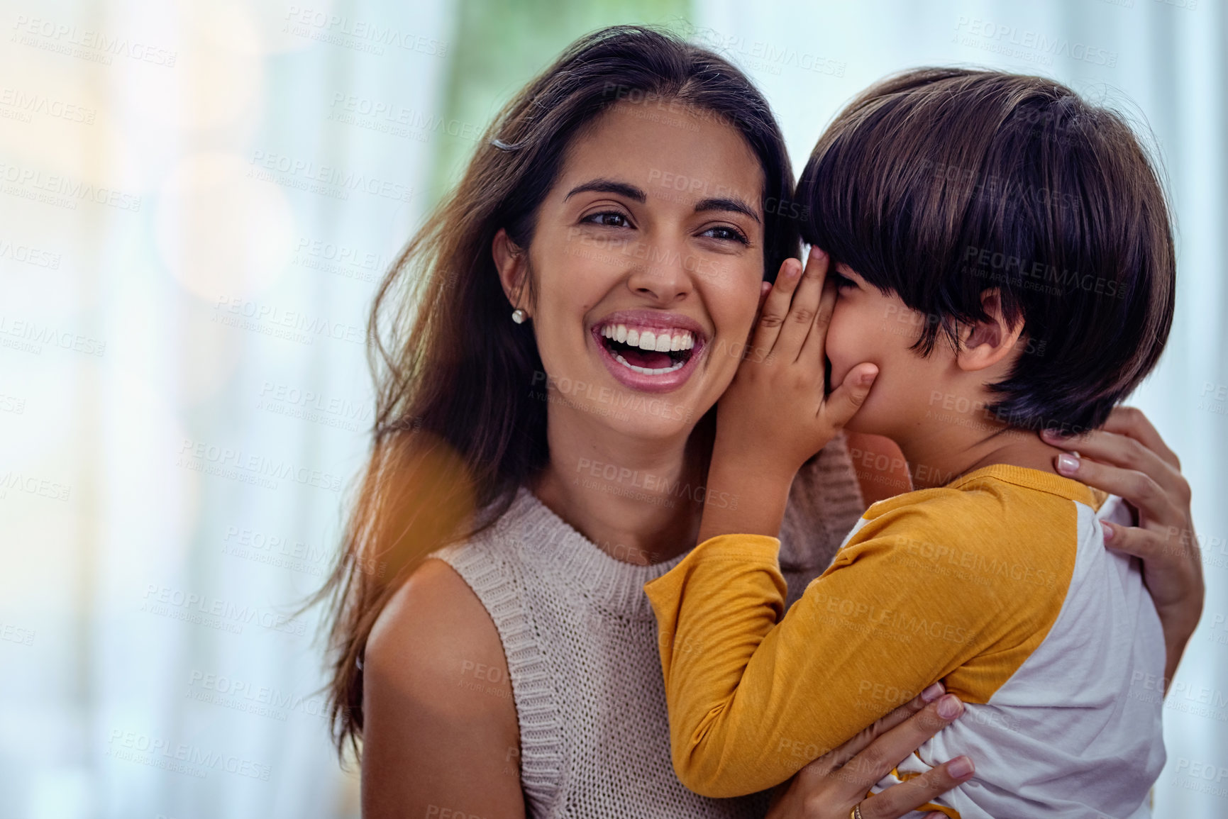 Buy stock photo Shot of an adorable little boy whispering into his mother’s ear