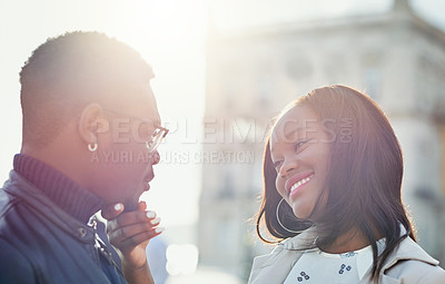 Buy stock photo Shot of an affectionate young couple bonding together outdoors