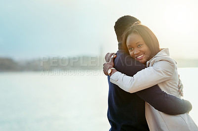 Buy stock photo Shot of an affectionate young couple bonding together outdoors