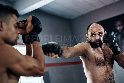 Buy stock photo Cropped shot of two male fighters training at the gym