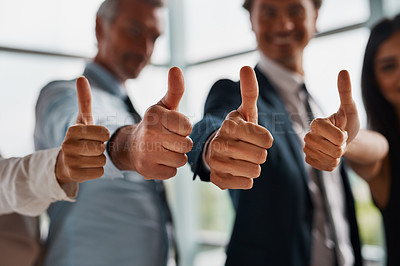 Buy stock photo Cropped shot of corporate businesspeople showing thumbs up in the office