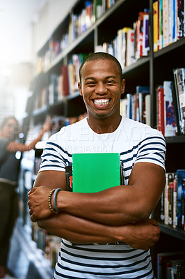 Buy stock photo Portrait of a happy young man carrying books in a library at college