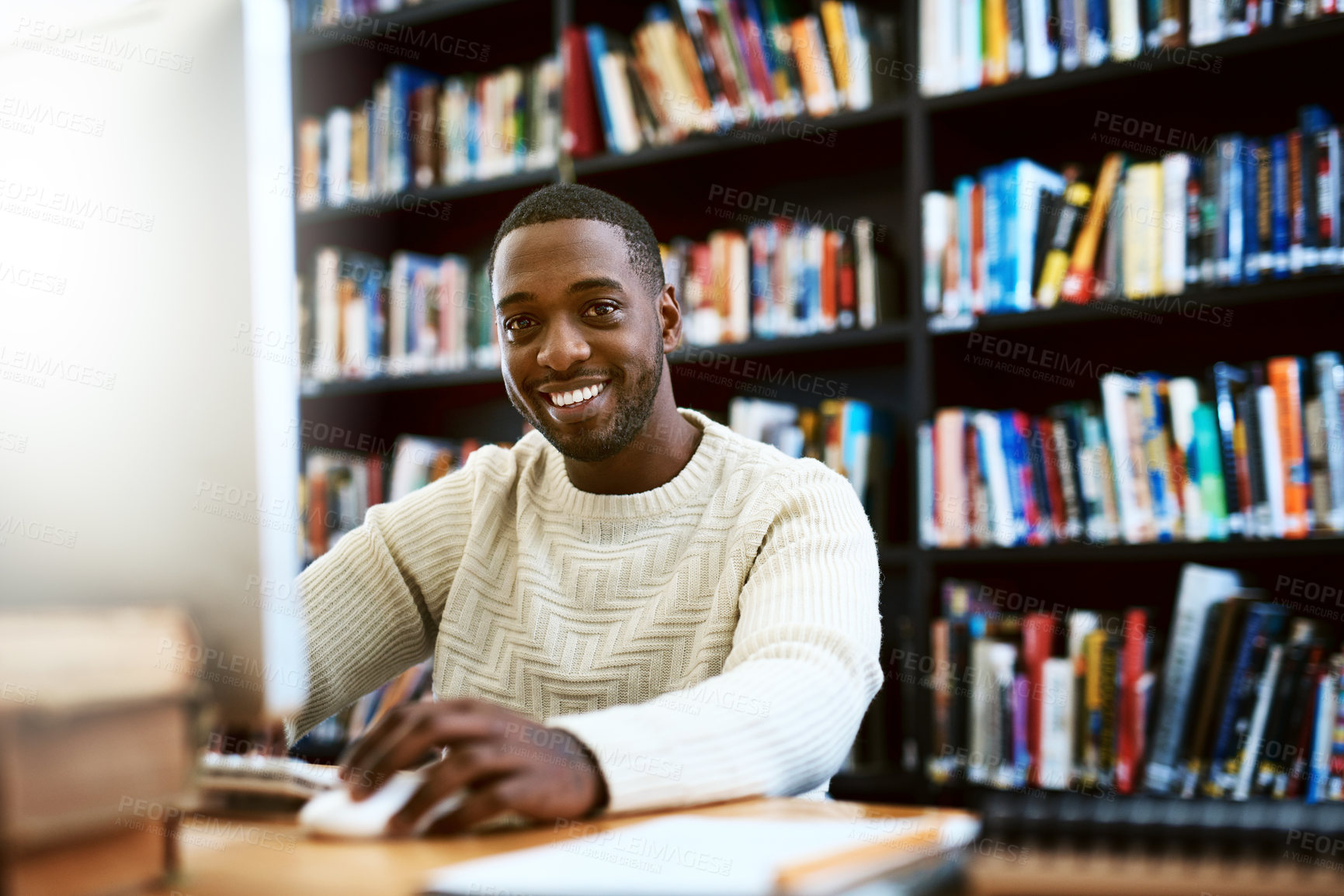 Buy stock photo Portrait, education and black man in a library, computer or research for a project, assignment or search website for information. Face, male person or student with technology, knowledge or connection