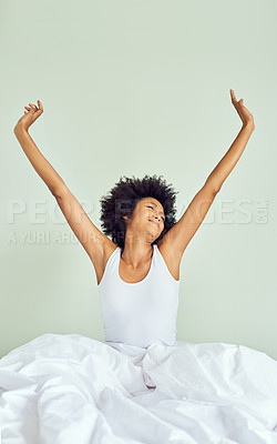 Buy stock photo Cropped shot of an attractive young woman waking up and stretching in bed at home